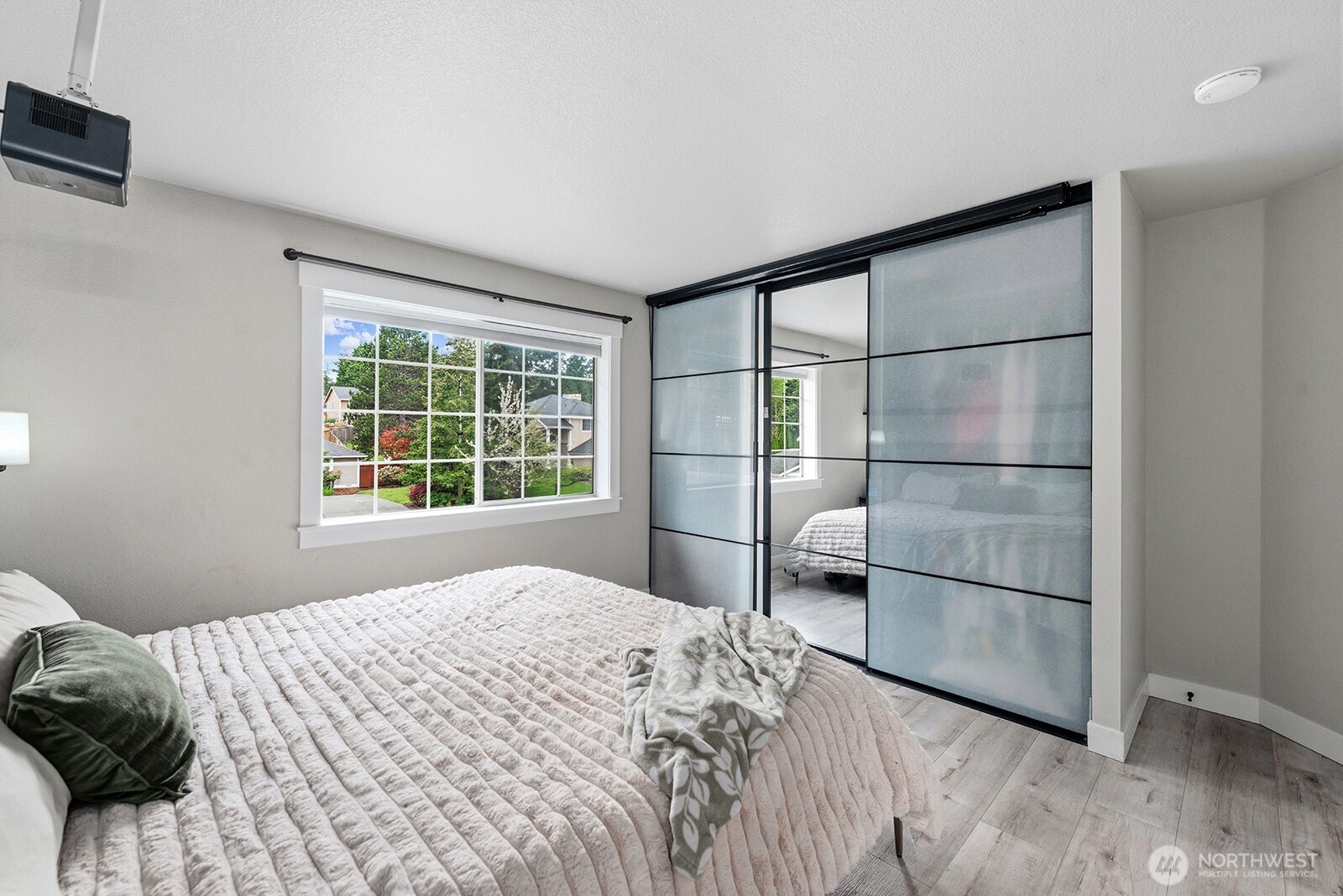 Primary suite has 2 closets. The one pictured here has closet organizer and projector above it.