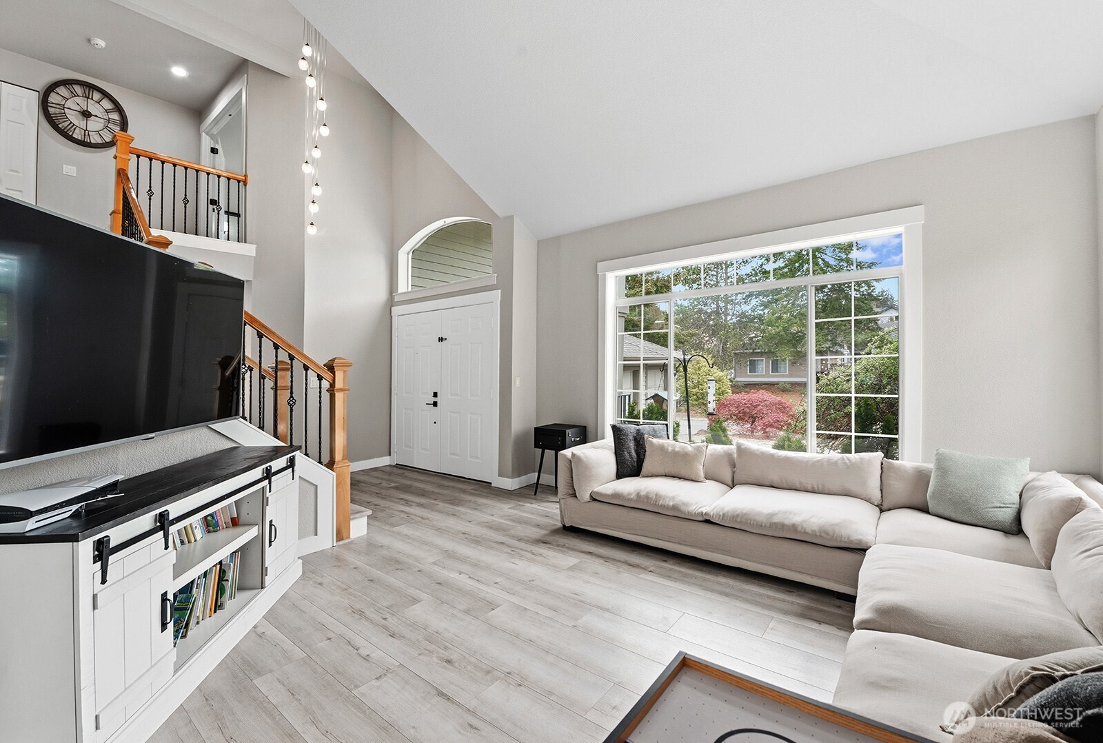Double door entry and covered front porch lead into the vaulted ceiling living room.