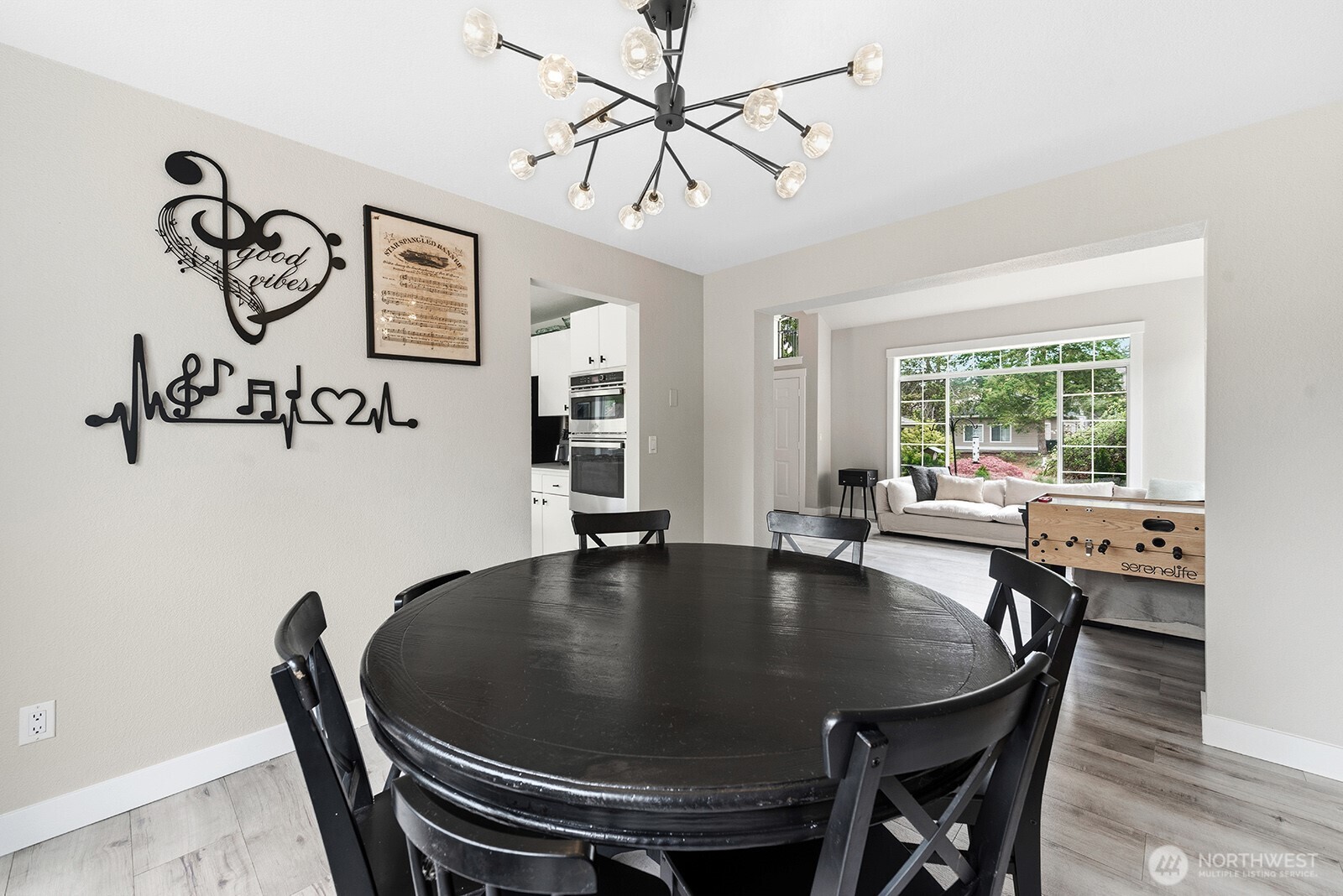 Dining room opens up into the vaulted ceiling living room allowing natural light to flow through both spaces.