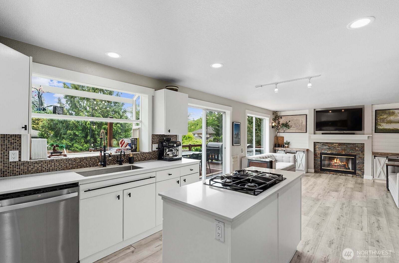 Kitchen with hard surface counter tops throughout.