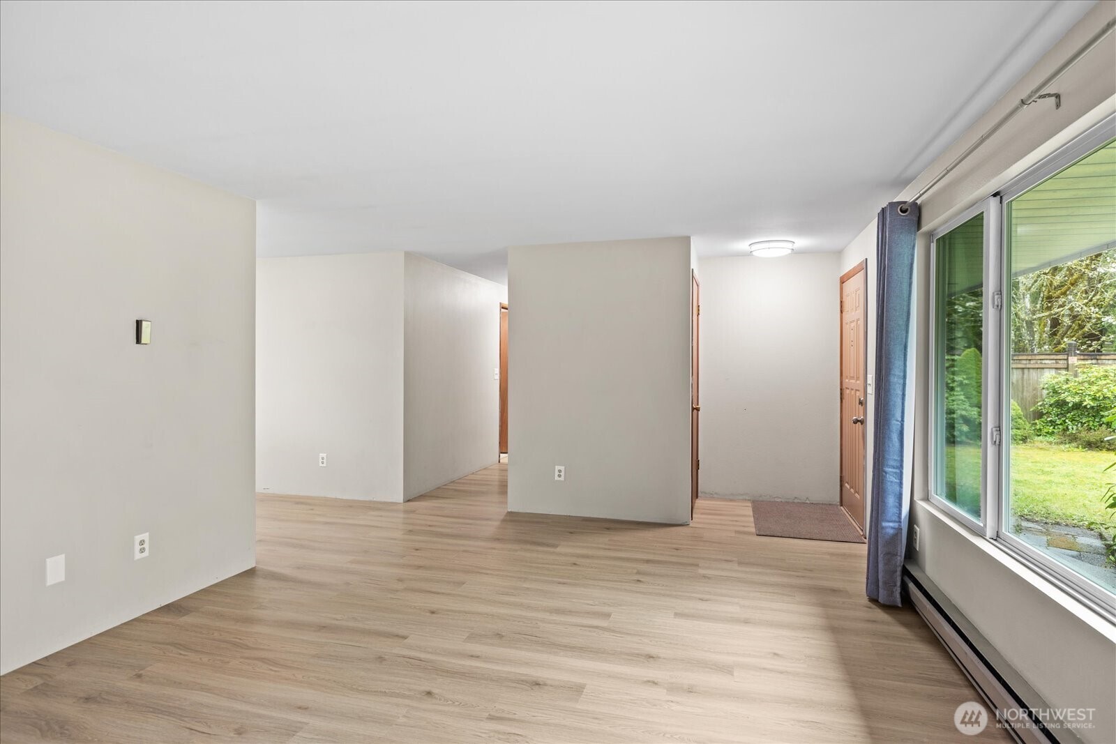 Hallway off of dining room and living room leads to the bedrooms and bathrooms in the home.