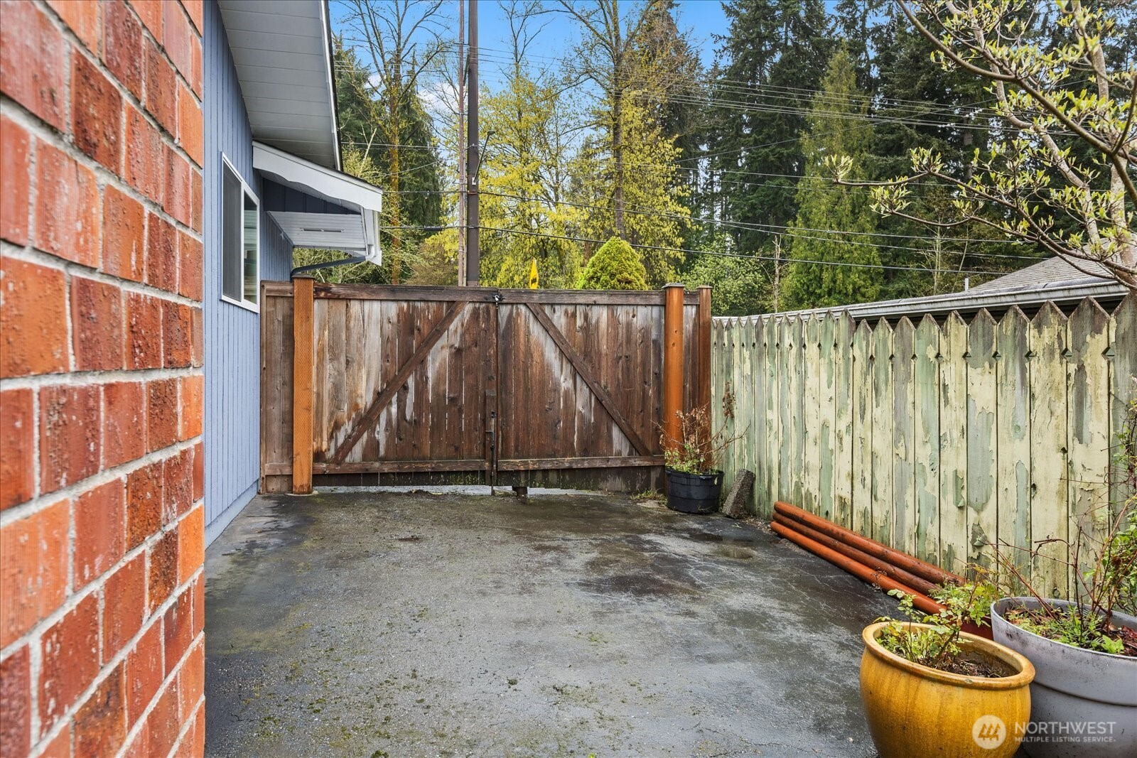 Gated side area is a flexible space for possible extra parking, storage, or weekend projects.