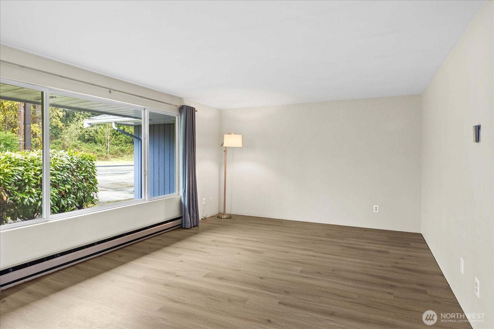 Living Room features large picture windows, allowing ample natural light.