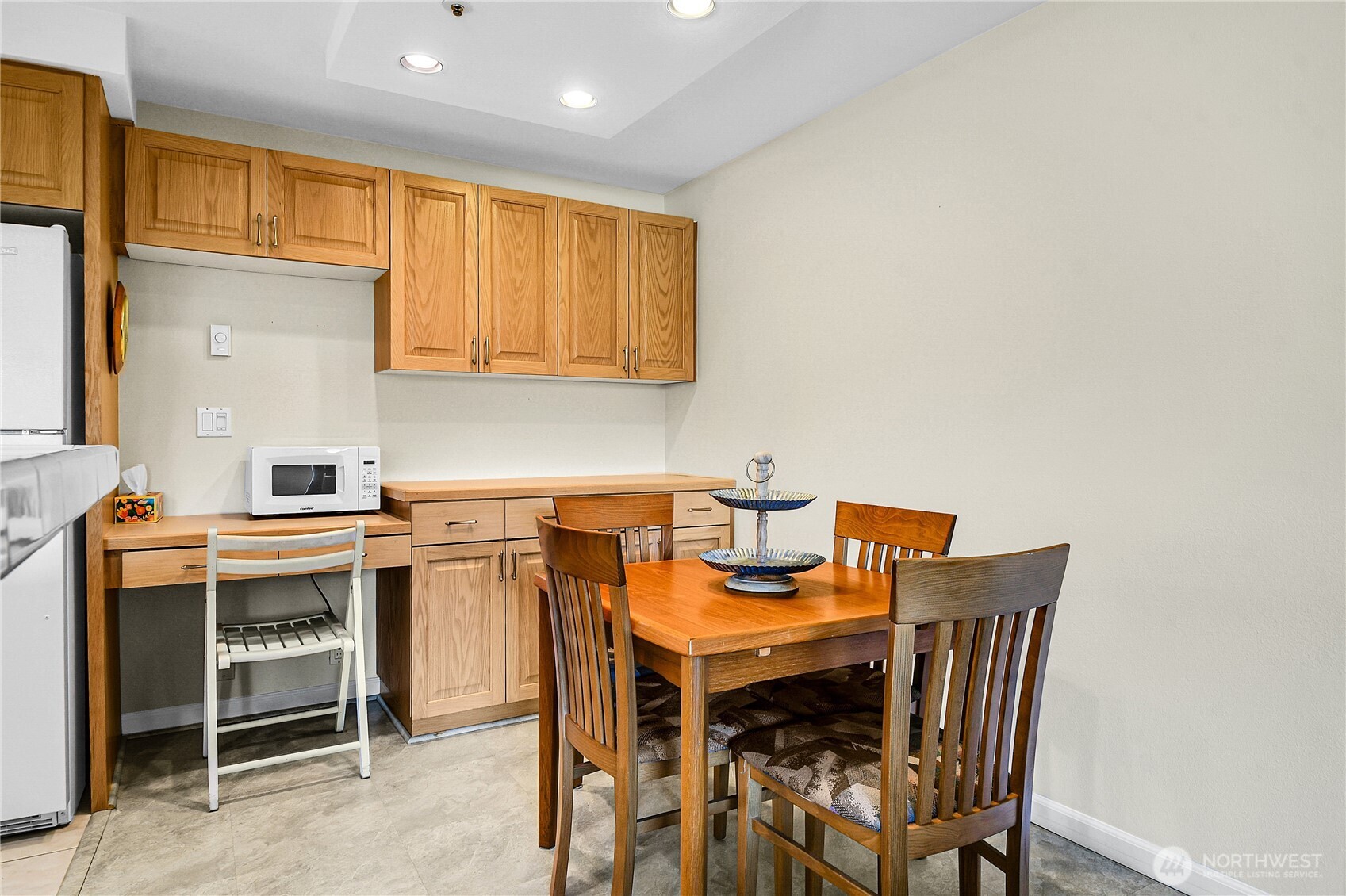 Entering dining area from livingroom.  Cute work desk is built into the cabinetry