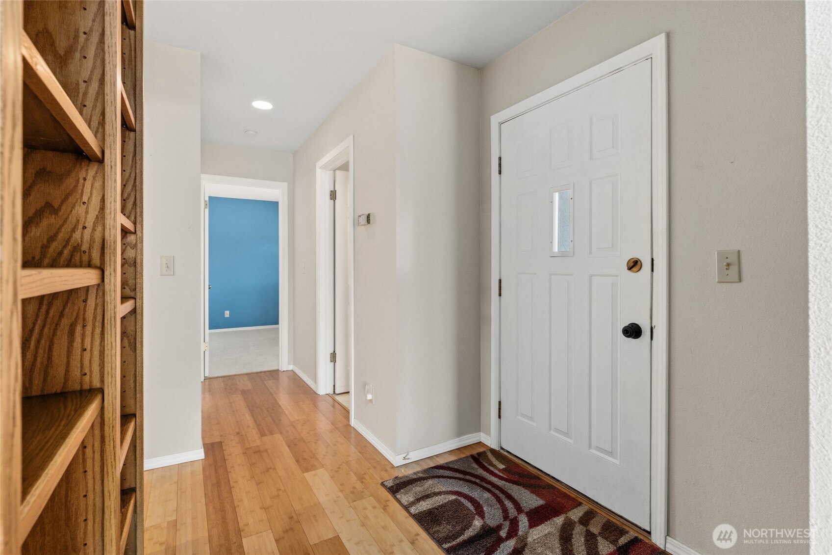 Front Entry door and hallway to bathroom and bedrooms