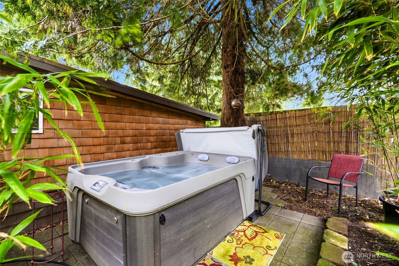 The expansive, level lot is a gardener’s dream with fruit trees, greenhouses, raised beds, mature landscaping, and multiple sun and shade zones