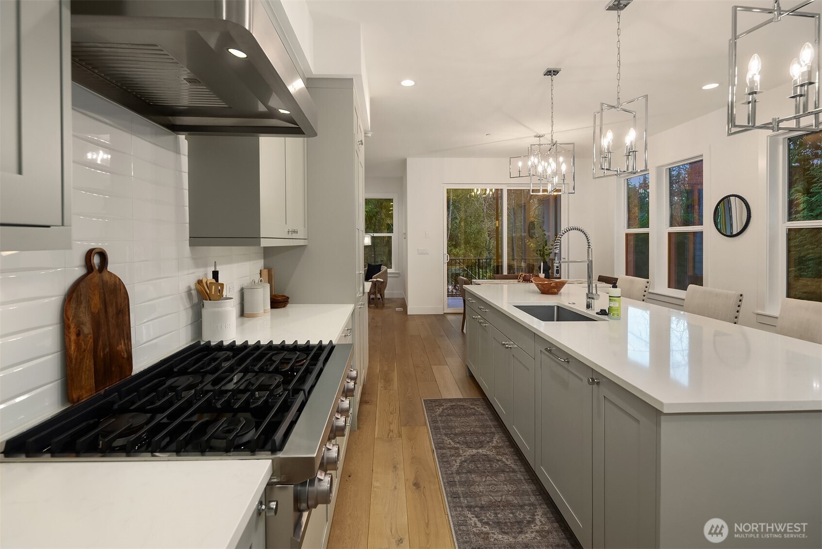 You'll love cooking on this oversized gas stovetop with six burners and sleek stainless-steel hood above.