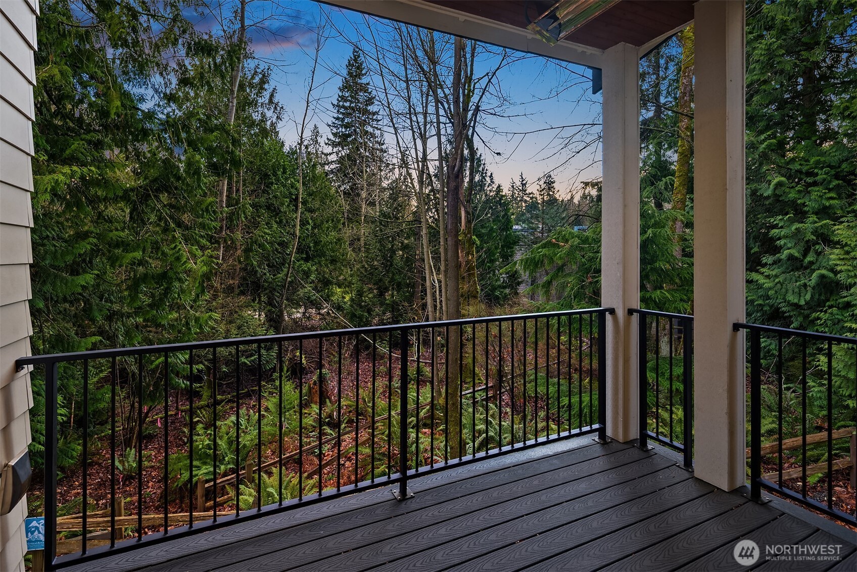 Off the covered deck are lush green views of serene nature. Don't miss the built-in heat lamps above to keep you comfortable on chilly nights.