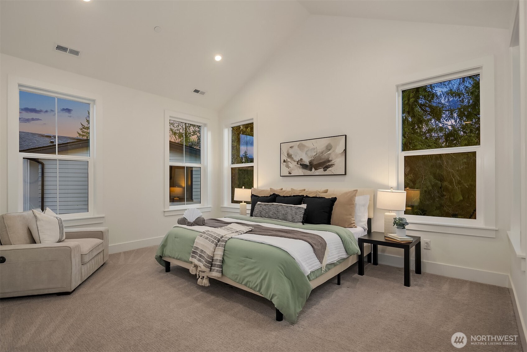 The primary bedroom feels expansive yet draws you into comfort and style. The vaulted ceilings and abundant windows bounce natural light all over the room.