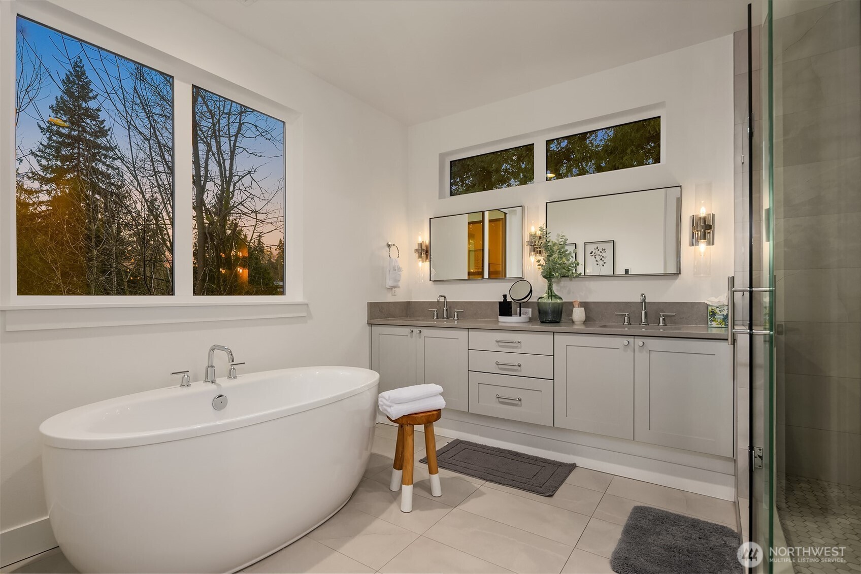 A spa like primary bath greets each morning with refreshing light and serenity and welcomes the evening with a calm, relaxing soak in the tub.