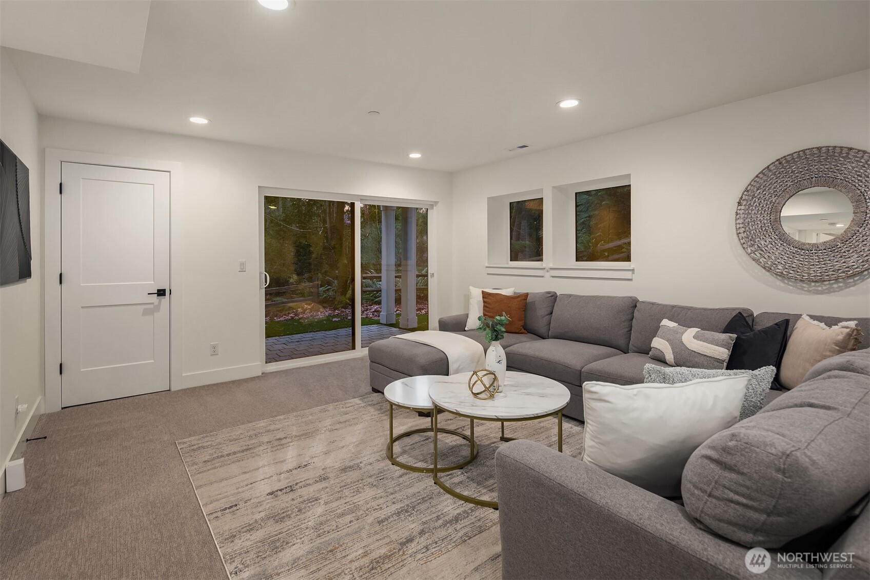 The lower level is a daylight basement, generous in space, flexing a large rec room with a walk-out covered outdoor space to enjoy.