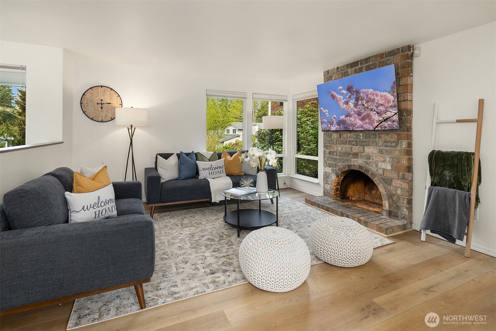 Open concept living room with lots of natural light, updated fixtures and great flow into the kitchen/dining space