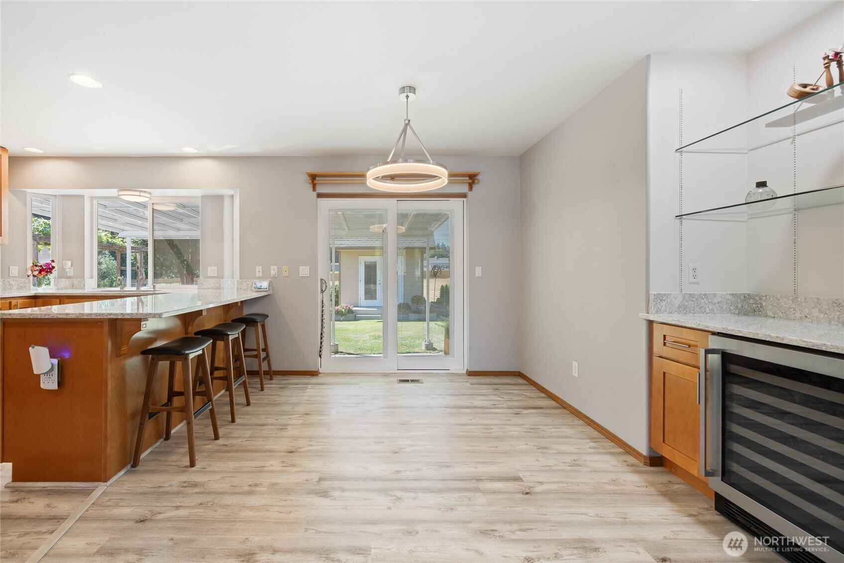The kitchen was remodeled in 2023 with quartz countertops, upgraded hardwood cabinetry, and a built-in 48-bottle wine fridge. Durable LVP flooring runs throughout the home, paired with LED lighting for a bright, modern feel. The hot water tank was replaced in 2023, and the home features an electronic air filter with a REME HALO ionizer for improved air quality. Generator-ready circuitry and a 200-amp electrical panel add peace of mind....