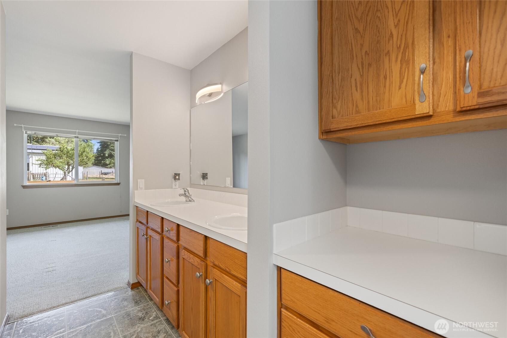 The primary suite is thoughtfully designed with custom California Closets and an ensuite bath. The bathroom features a six-foot soaking tub and a cable TV hookup, and all rooms in the home are wired for cable, including the primary bath.