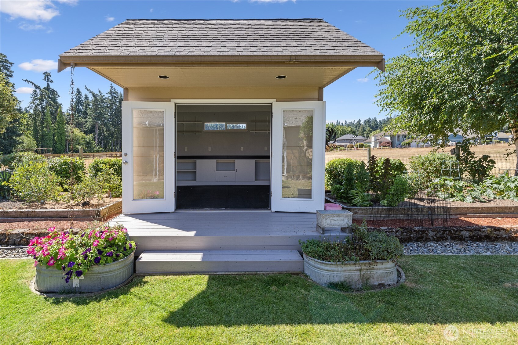 The creative cottage is heated and fully insulated, making it comfortable year-round. Six dedicated solar panels support efficient use, while built-in cabinetry and durable rubber mat flooring add functionality. French doors bring in natural light and charm, and a small loft offers additional storage or flexible creative space.
