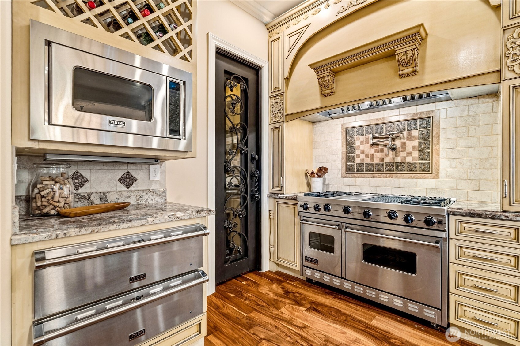 Viking appliances including range with 4 burners, griddle, and grill. Warming drawers, and built in microwave