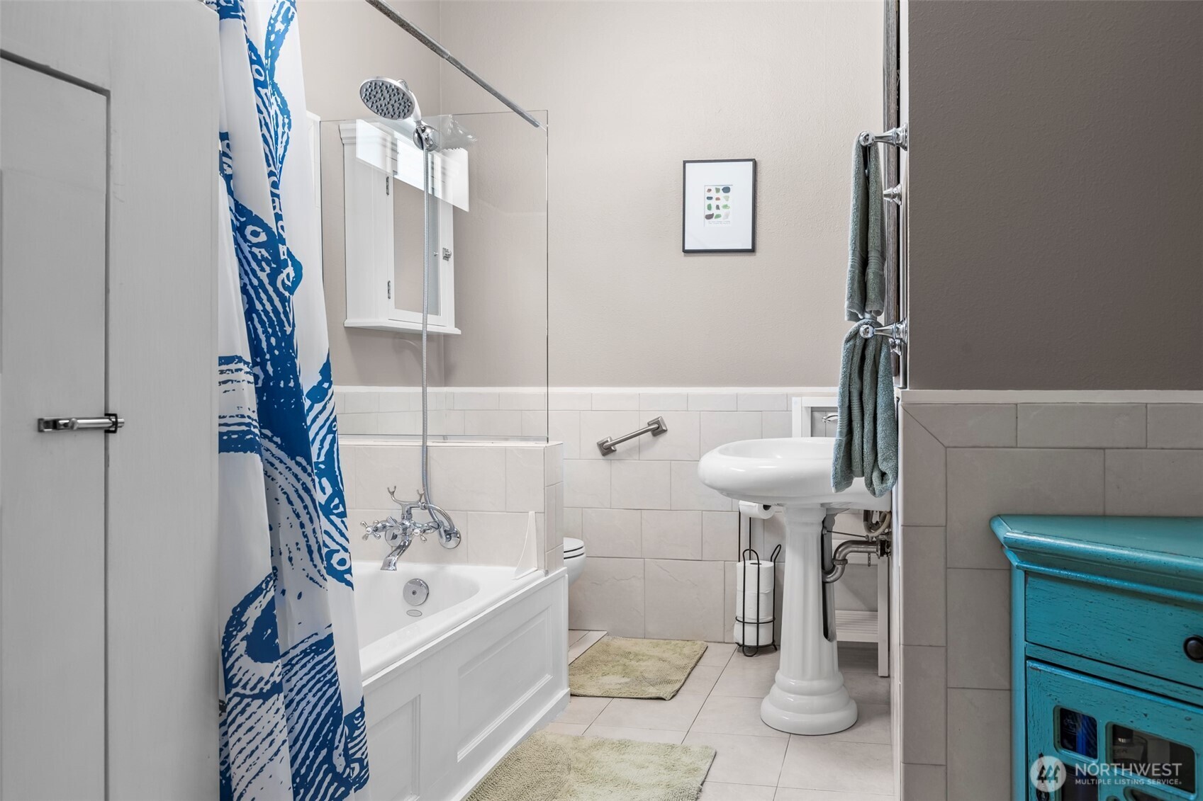 Main floor bathroom w/ tub and tiled floors