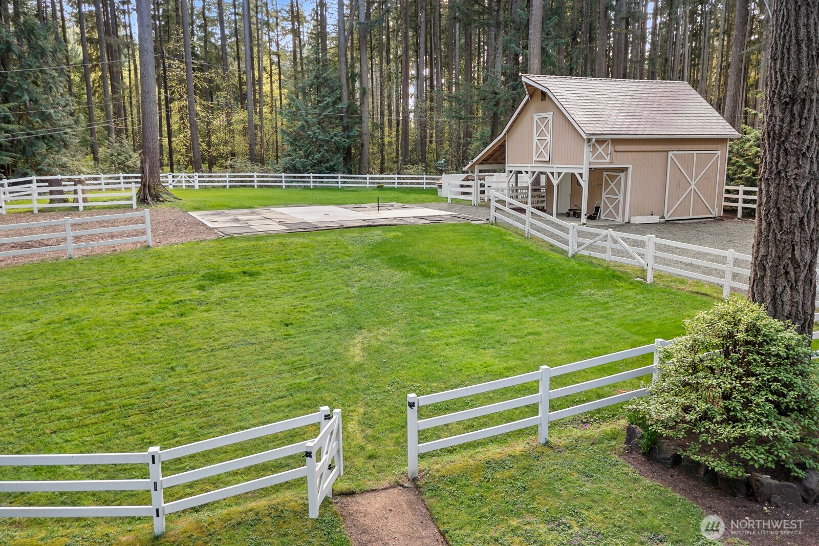 Barn w/ hay loft, shavings bin, tack storage, and grooming area. Potential for stalls.