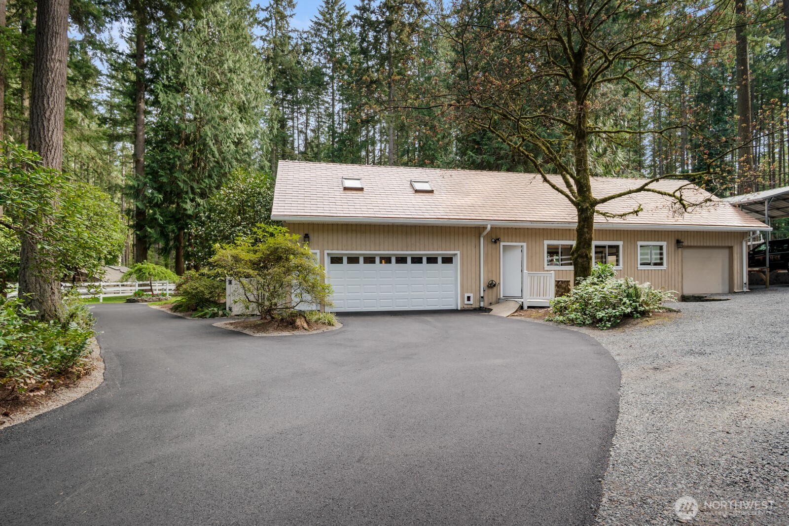 Freshly paved driveway and brand new garage door