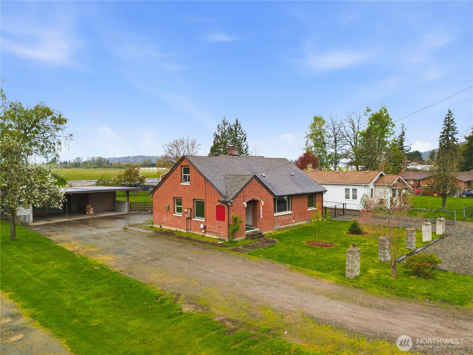 Spacious lot with a long driveway offering plenty of room to spread out, surrounded by mature landscaping.