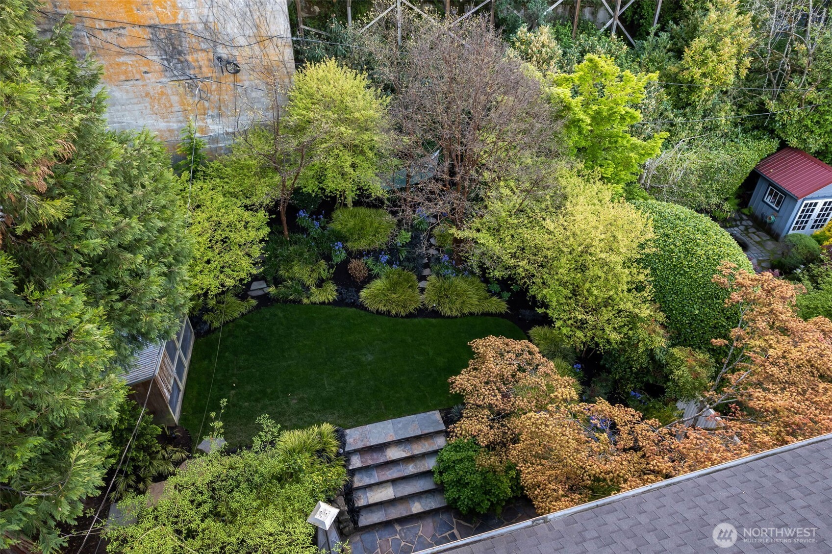 Mature landscaping that is professionally managed creating a private respite. There's even a hammock nestled in there.