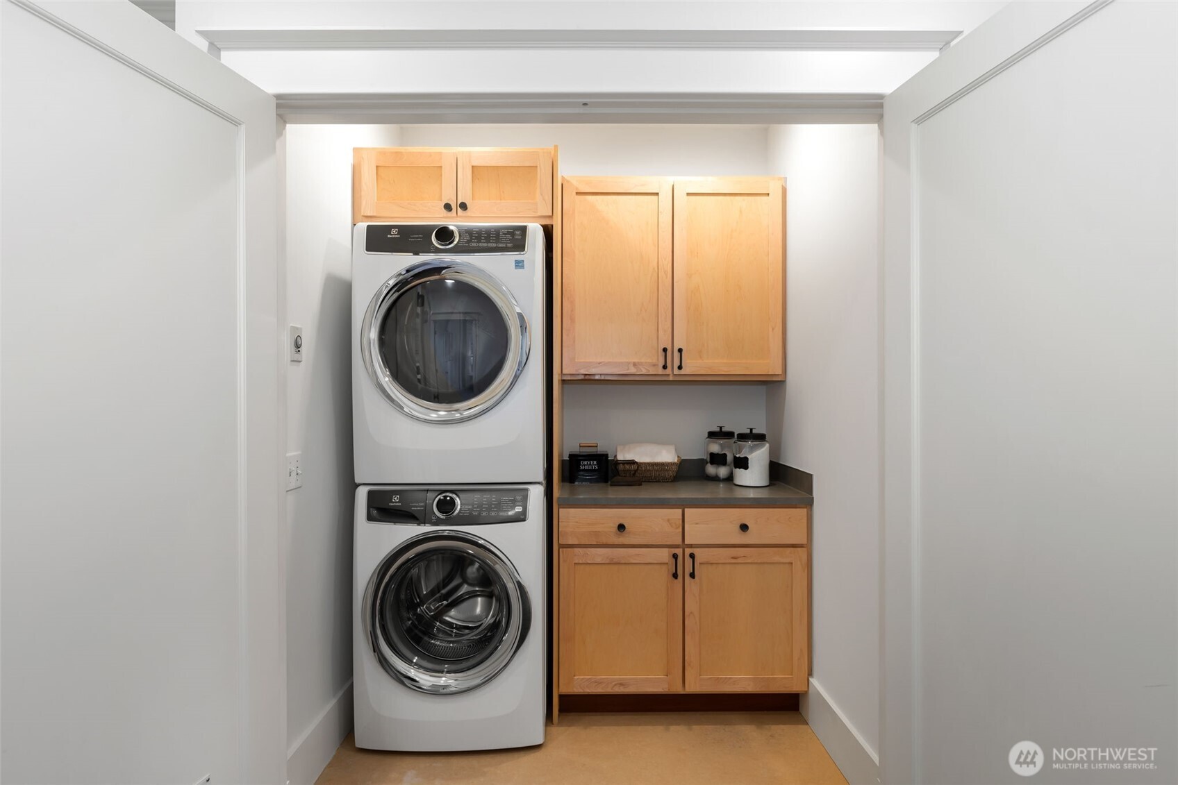 Walk-in laundry room with plenty of room for hampers, folding and storage.
