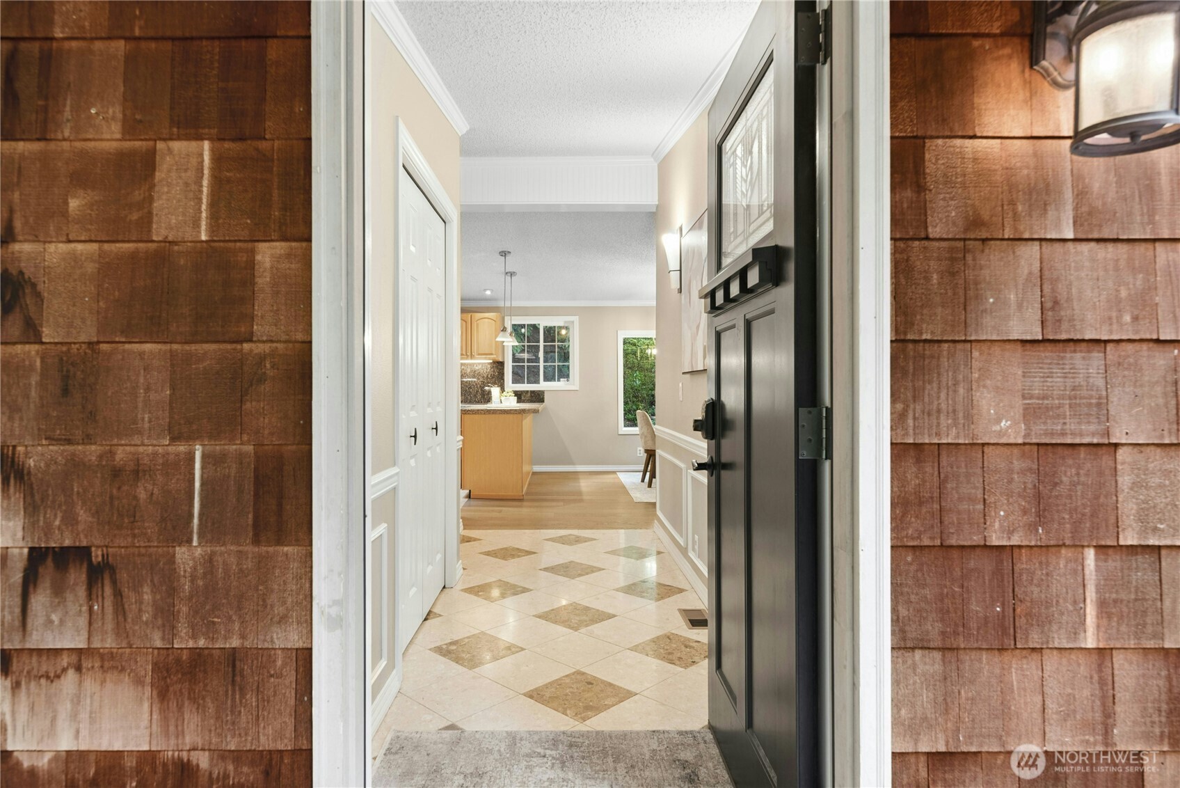 As you enter from the covered front door entry, there is a large coat closet on the left with custom tile flooring.