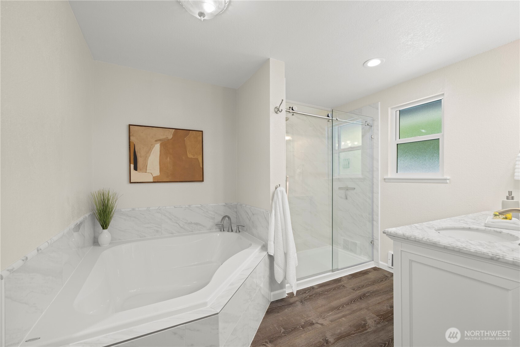 Luxurious primary bathroom with soaking tub & walk in shower