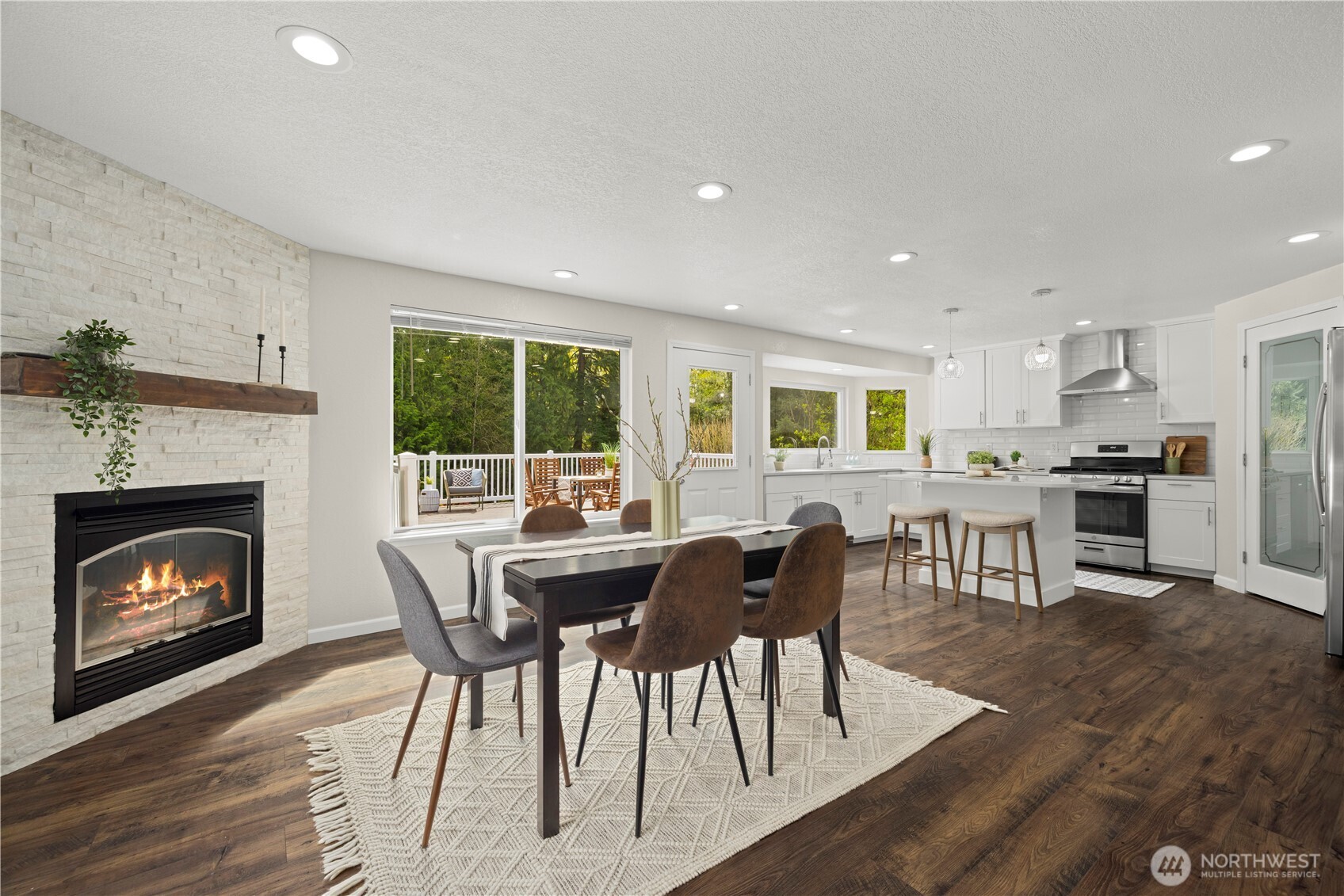 lovely modern kitchen and dining room with fireplace. Tons of natural light and direct access to the deck.