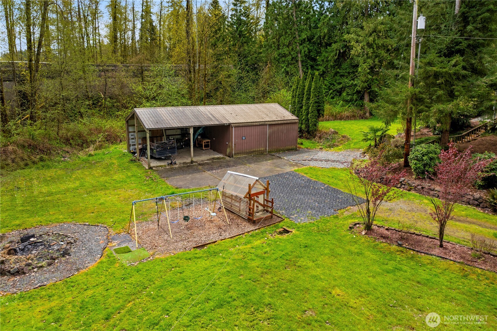 Large shop with additional carports, previously used as home gym-- possibliities are endless. Swing set/play area, firepit.