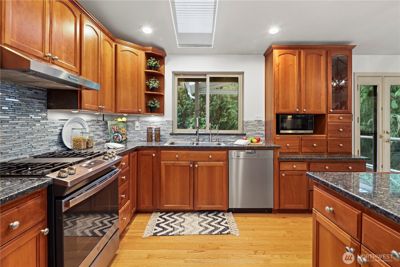 SS appliances all stay - there's also a skylight above the sink area for additional light