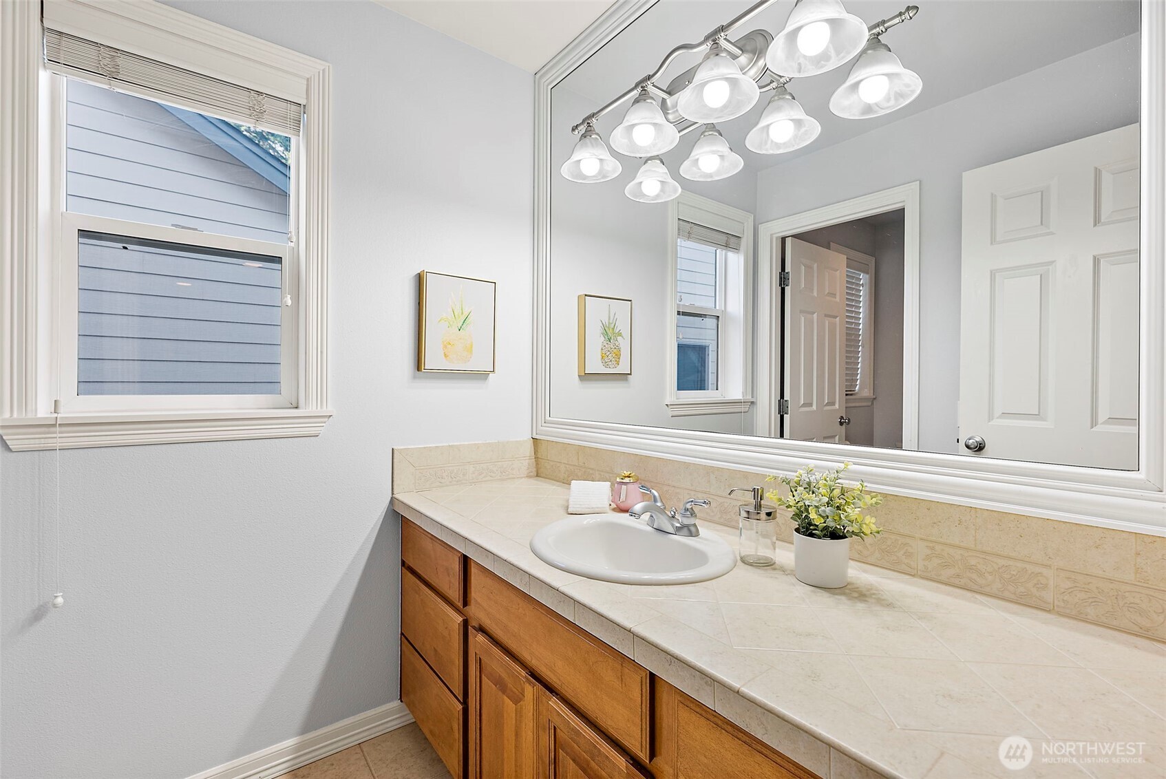 Spacious laundry area with door leading to garage.