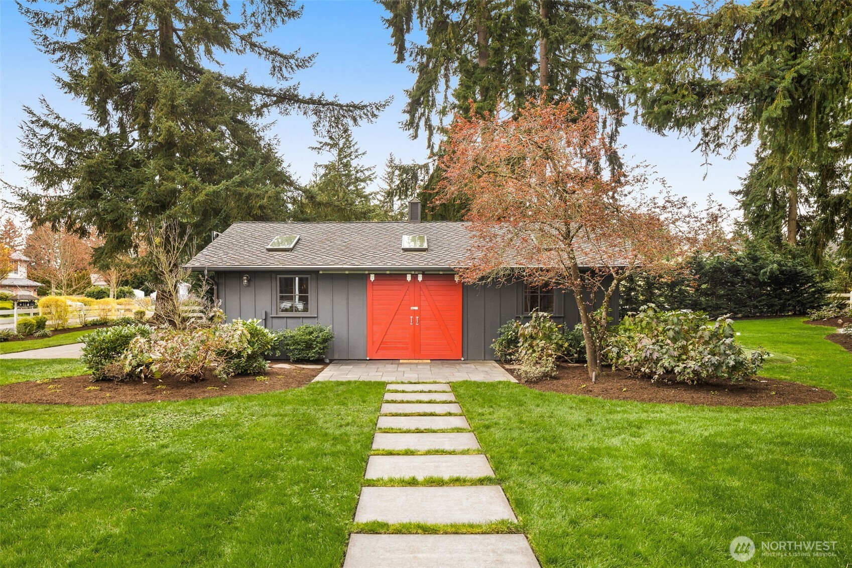 The converted barn, now the golf and fitness lodge, which boasts a golf simulator, putting green, a professional-grade gym, and basketball court.