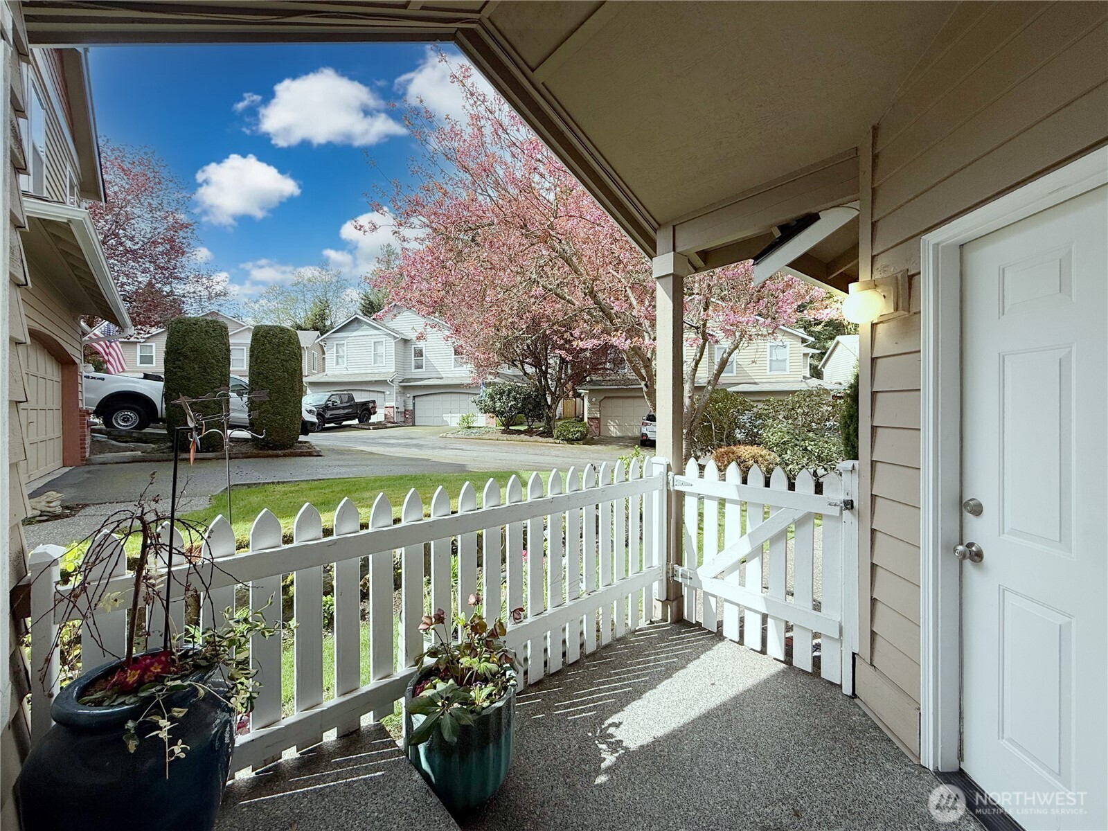 Picket-fence dreams with your private front porch area and  door leading to the 2-car garage