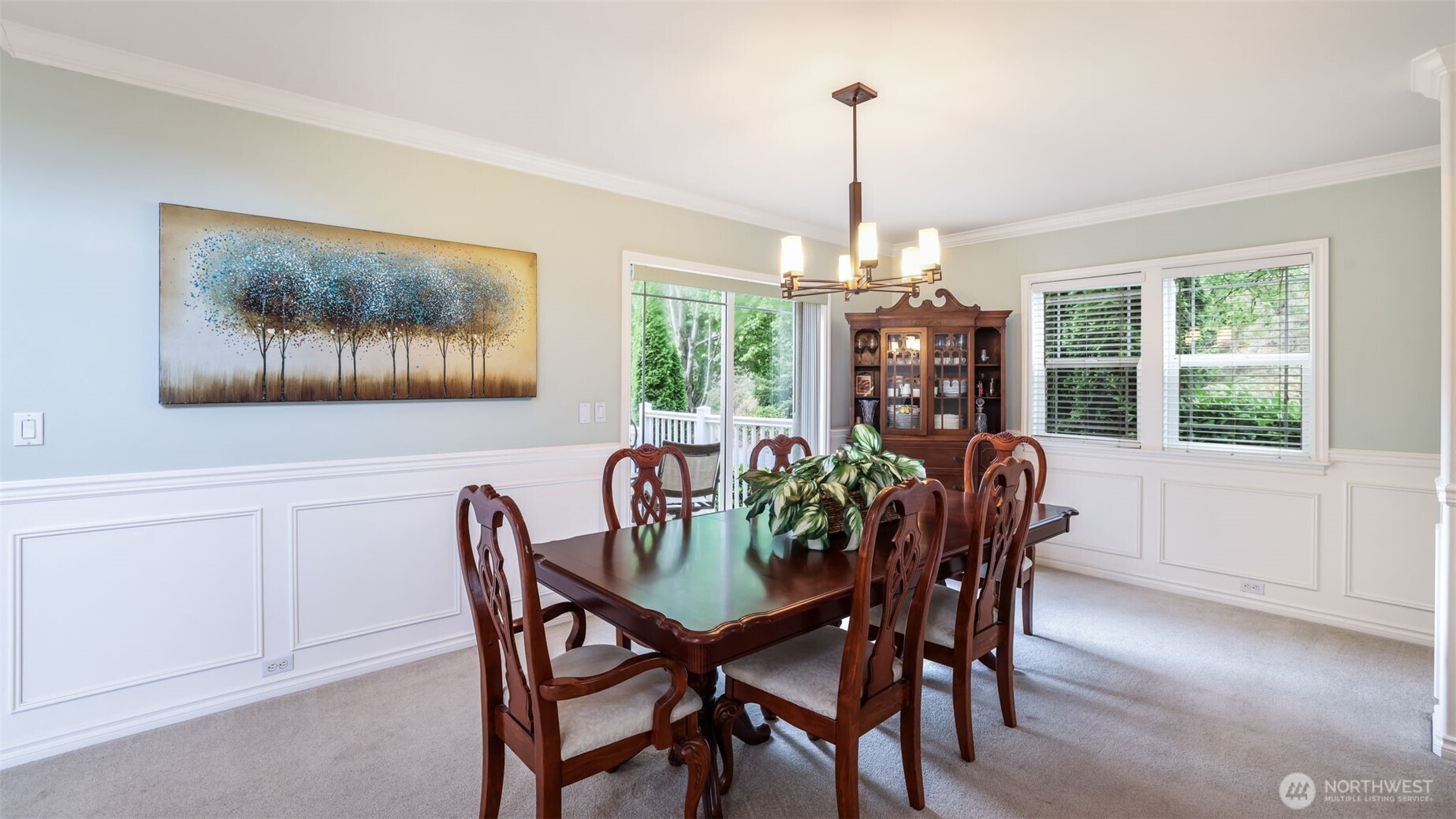 This formal dining space flows seamlessly to the outdoor seating area for effortless entertaining.