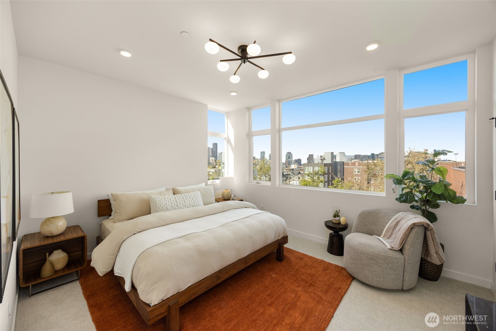 The primary suite serves as a serene retreat with expansive windows and city views.