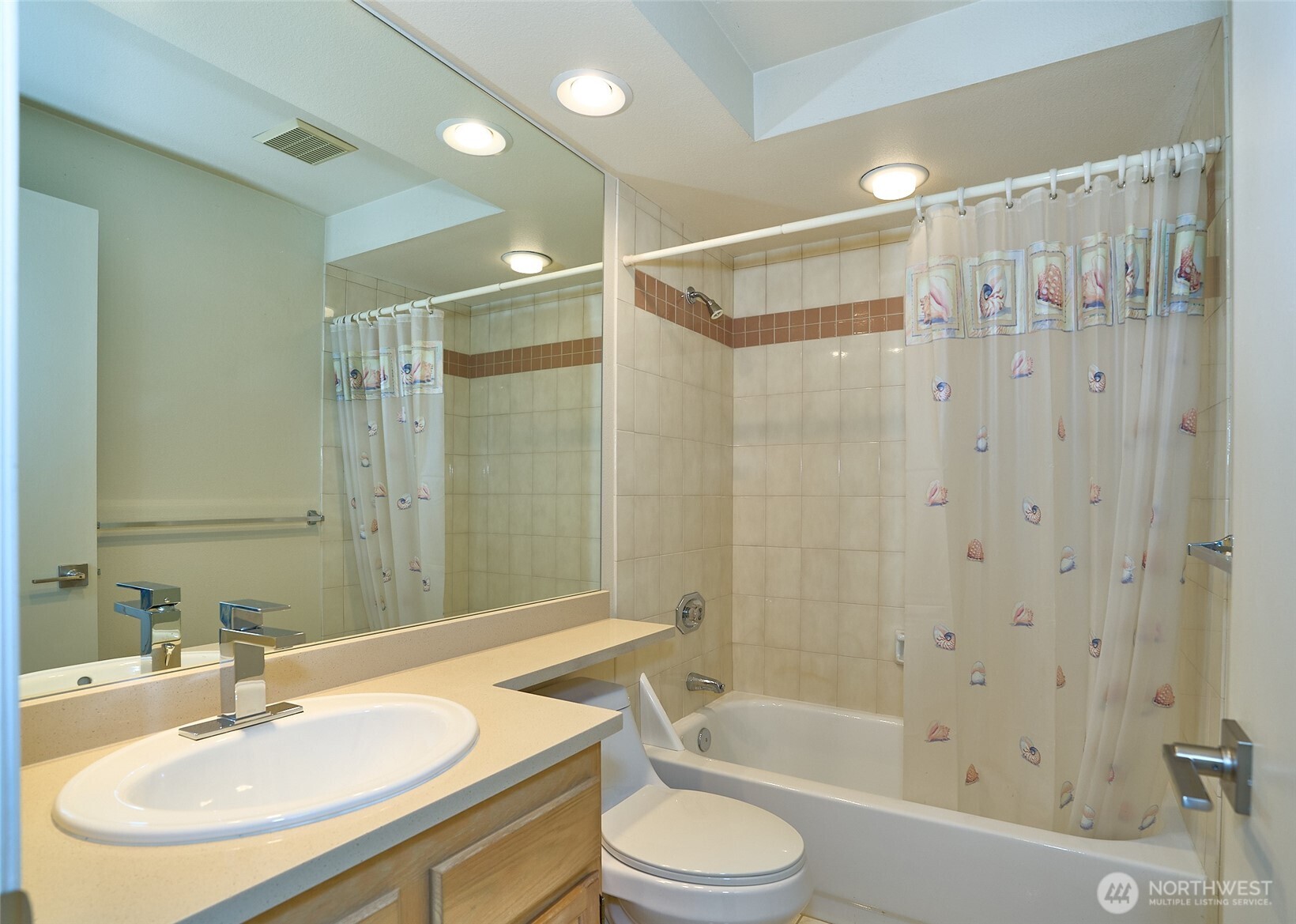 A main upstairs full bathroom also featured in this home has a quartz counter top as well..