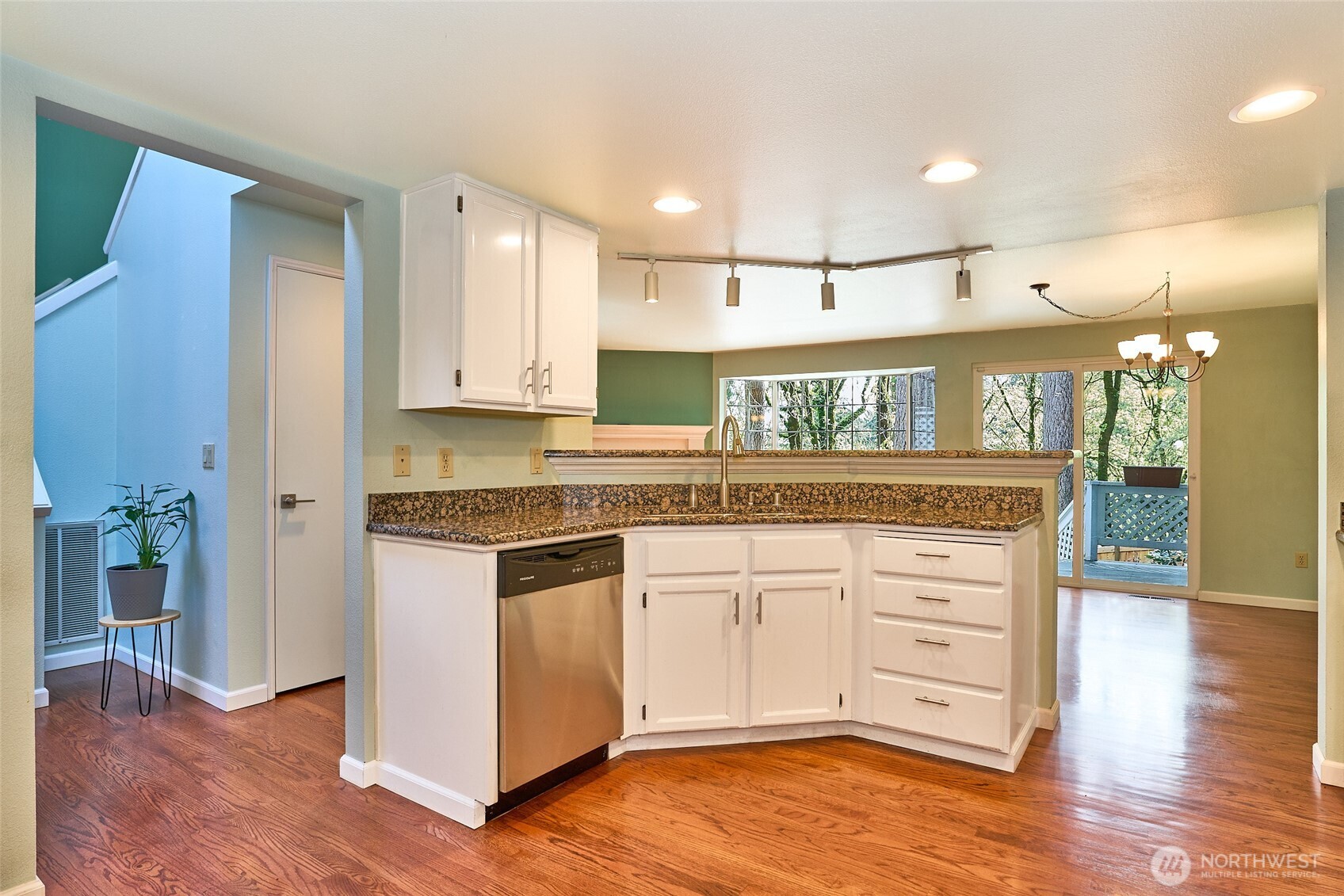 remodeled open kitchen offers a lot of cabinets, drawers and granite counter tops.