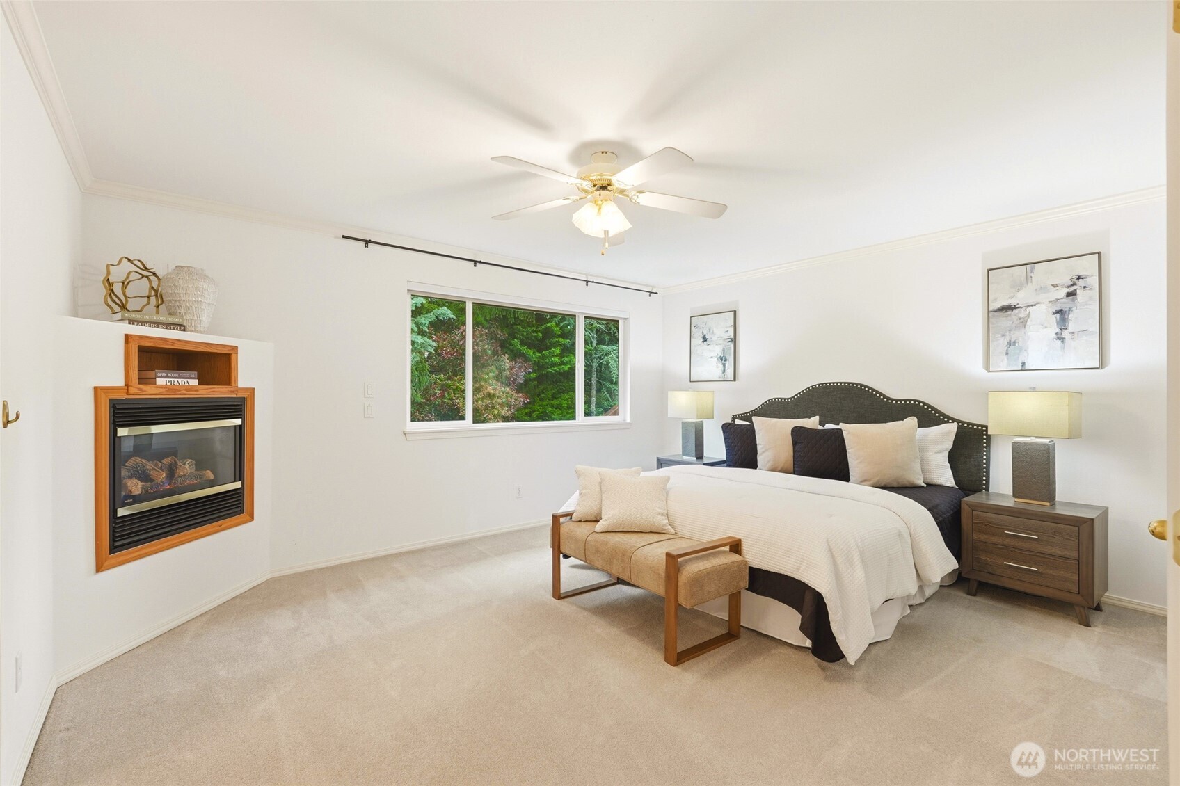 primary suite with fireplace and ceiling fan