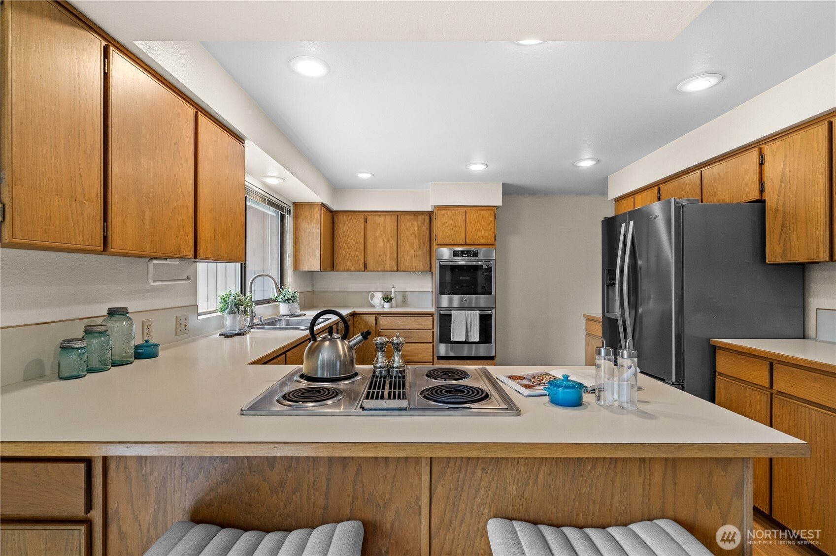 Bar stool seating is featured at the peninsula—perfect for casual meals or conversation while cooking.