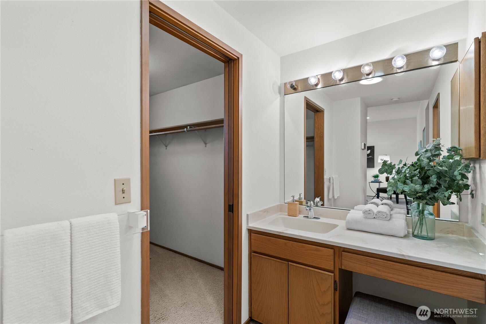 A vestibule-style area in the Primary Bath offers a built-in vanity with sink in addition to the adjacent full-sized bathroom.  This configuration is certain to make your morning rituals go smoother!