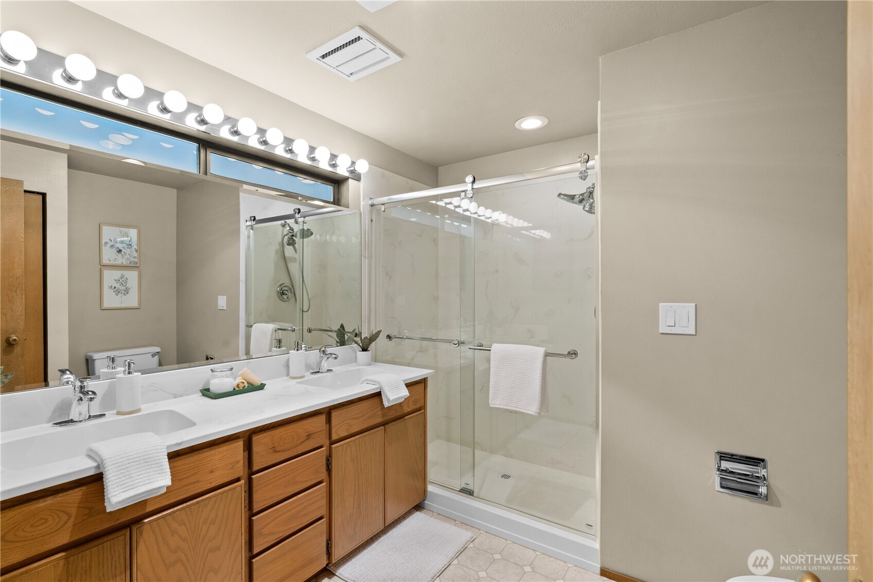 The primary bath has been updated with a double sink vanity and a large, walk-in shower.