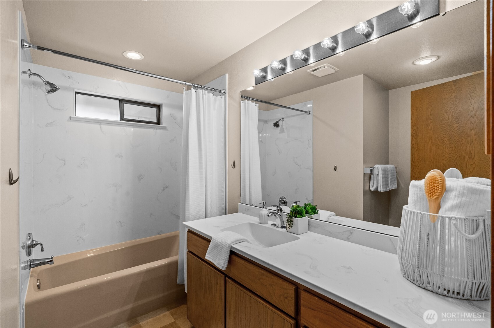 The hall bathroom features a large vanity with plenty of storage space.