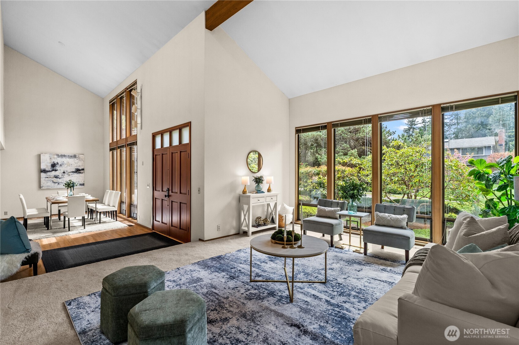 A striking, vaulted entry and expansive foyer is featured here.  Natural light pours in through dramatic two-story windows.