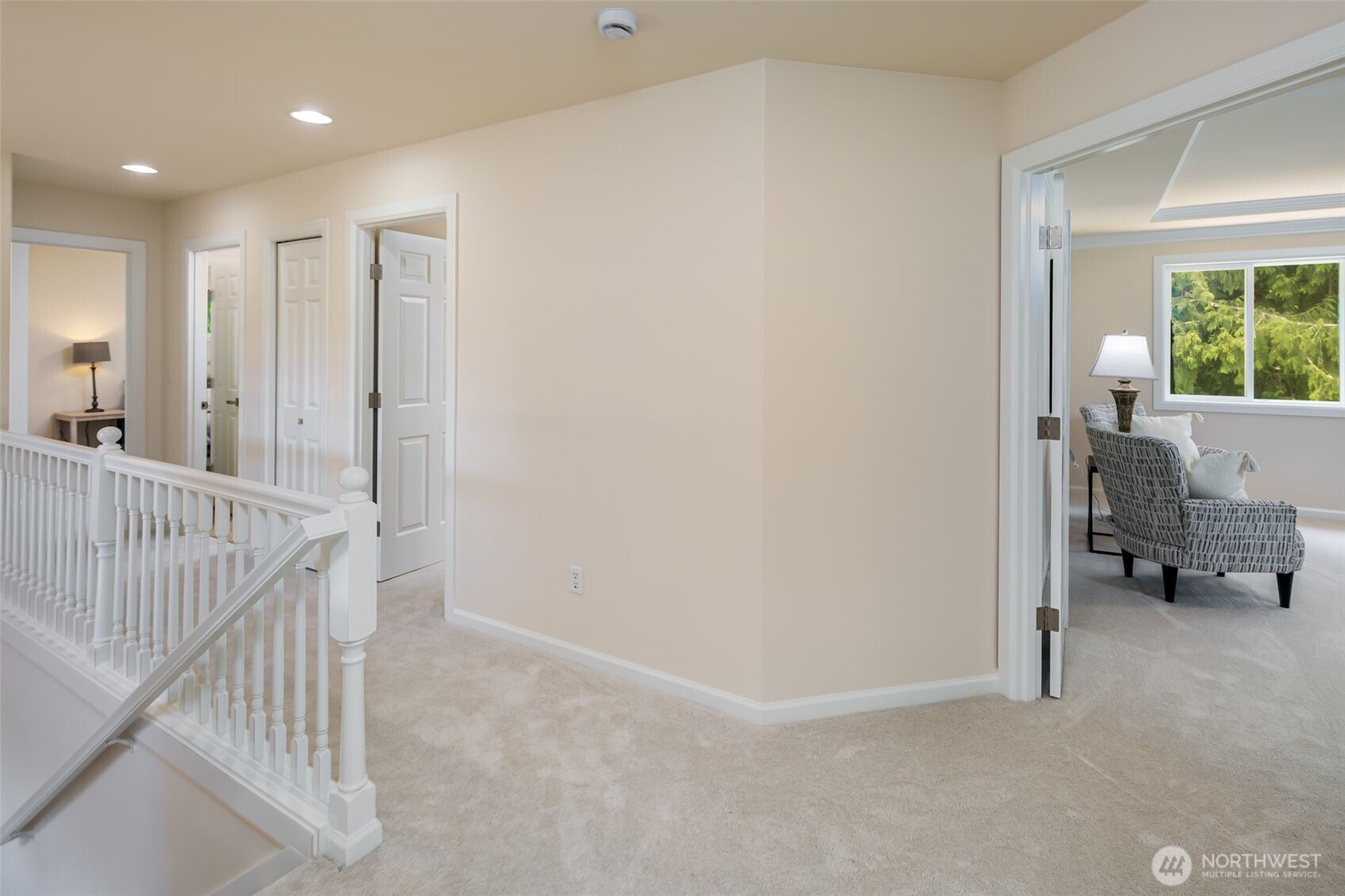 Primary bedroom with Walls of windows that overlook the backyard.