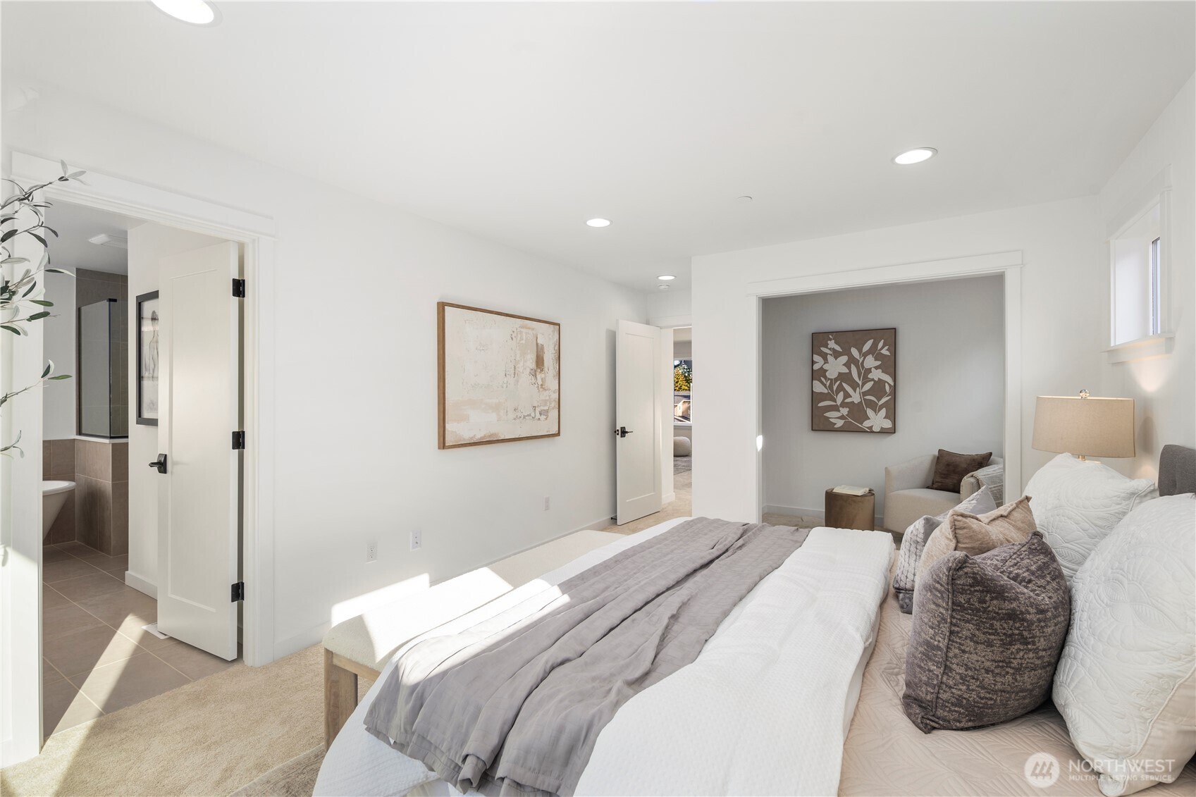 Primary Suite – Expanded View:  This wider perspective highlights the suite’s spacious layout, recessed lighting, and direct connection to the spa-inspired bath and attached sitting room. Its thoughtful floorplan promotes easy flow between rest, dressing, and relaxation areas. Being part of the Canyon Park community in Bothell means the suite sits moments from everyday conveniences, Northshore schools, and outdoor recreation. The overall scale invites a sense of calm and allows you to shape the space to match your preferred style of retreat.    These photos are from Lot 5 at Gooden Hollow, the community model. The home listed will have changes, so all photos, renderings, site maps, and floorplans are for visualization purposes only. Plans, colors, building orientation, finishes, home outlook, and other details can and WILL vary.