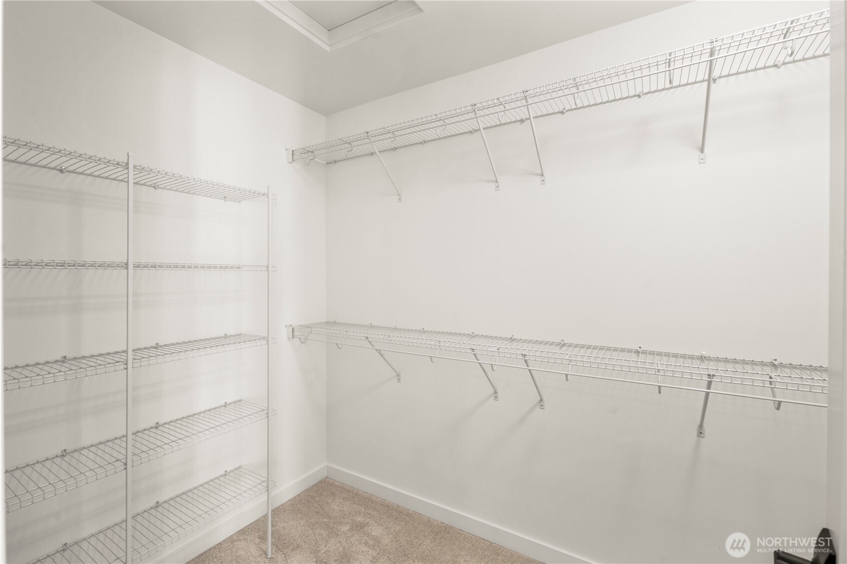 Primary Walk-In Closet:  The walk-in closet offers extensive built-in shelving and hanging space, creating an organized extension of the primary suite. Its layout maximizes capacity while keeping everything within easy reach. Thanks to the home’s location in Bothell’s Canyon Park area, the suite benefits from a peaceful residential environment close to shopping, cafés, and community conveniences. This well-sized closet adds everyday ease and helps maintain the calm, uncluttered feel throughout the suite.    These photos are from Lot 5 at Gooden Hollow, the community model. The home listed will have changes, so all photos, renderings, site maps, and floorplans are for visualization purposes only. Plans, colors, building orientation, finishes, home outlook, and other details can and WILL vary.