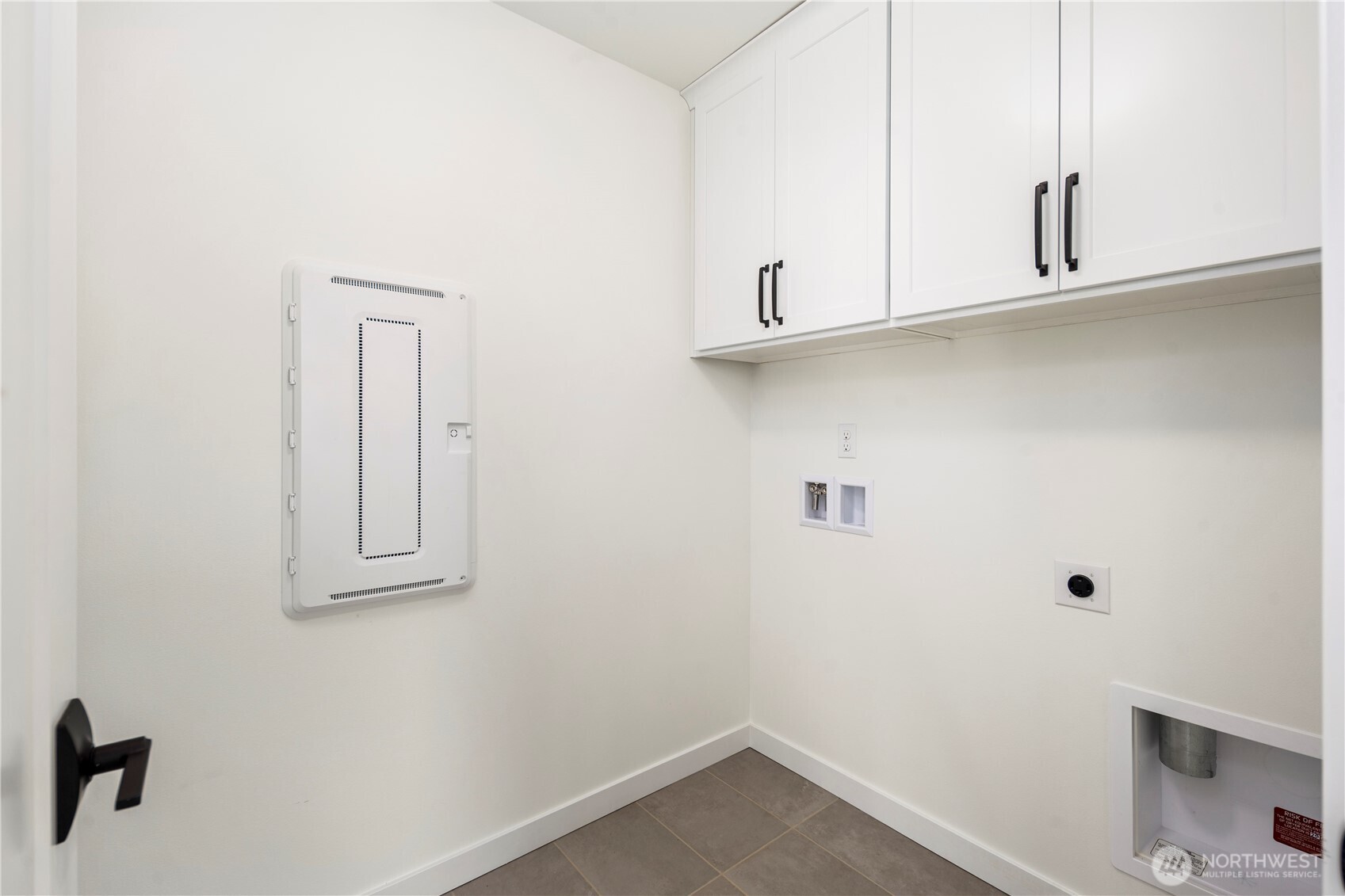 Laundry Room (Washer/Dryer Wall):  This dedicated laundry area includes upper cabinetry for organized storage and durable tile flooring designed for everyday function. Its location on the upper level keeps daily routines easy and efficient. With quick access to both Canyon Park conveniences and major Eastside routes, household tasks feel streamlined and integrated into daily living. The neutral palette and clean lines make it simple to pair with your preferred appliances and organizational systems.    These photos are from Lot 5 at Gooden Hollow, the community model. The home listed will have changes, so all photos, renderings, site maps, and floorplans are for visualization purposes only. Plans, colors, building orientation, finishes, home outlook, and other details can and WILL vary.