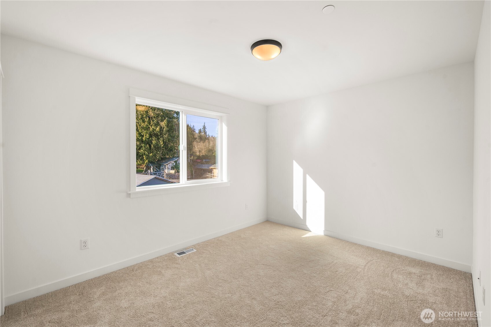 Secondary Bedroom (Rear-Facing):  This peaceful upper-level bedroom offers a serene treetop outlook framed by a wide window, along with plush carpeting and crisp white walls that keep the space feeling airy and open. Its balanced proportions make it versatile for a range of uses, with plenty of room to arrange furnishings comfortably. With the home situated near Bothell’s wooded greenbelts and nearby Northshore trails, the setting brings a quiet Pacific Northwest backdrop into everyday living. Its understated finishes create a calming environment that supports both productivity and relaxation.    These photos are from Lot 5 at Gooden Hollow, the community model. The home listed will have changes, so all photos, renderings, site maps, and floorplans are for visualization purposes only. Plans, colors, building orientation, finishes, home outlook, and other details can and WILL vary.