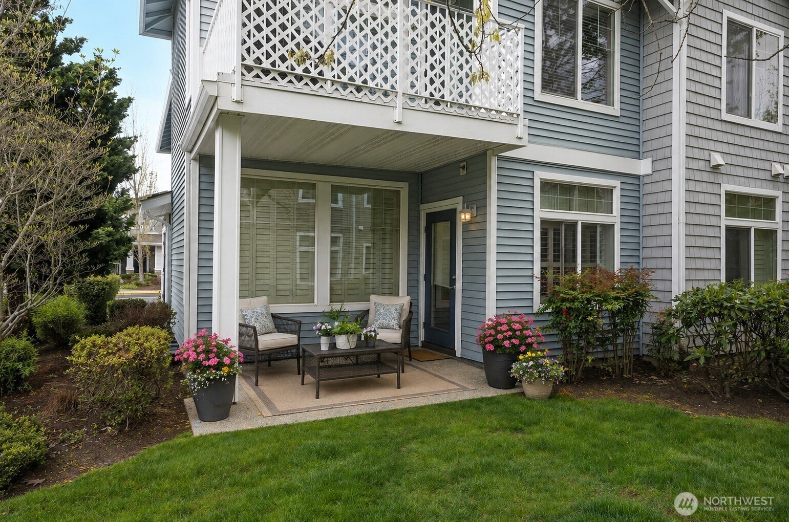Great covered patio space, perfect for relaxing and enjoying the beautifully maintained landscaping.